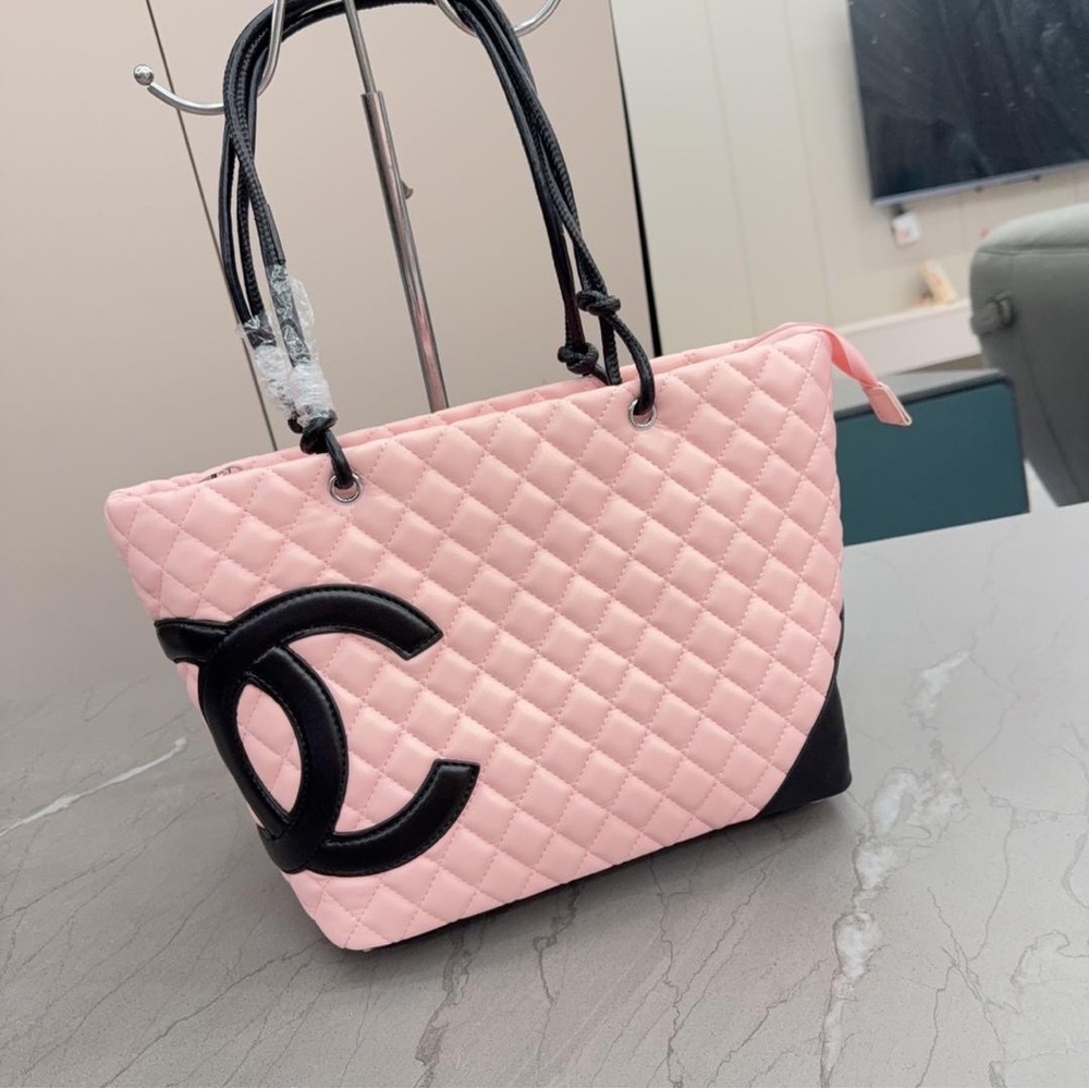CHANEL Light Pink Quilted Handbag with Black Logo